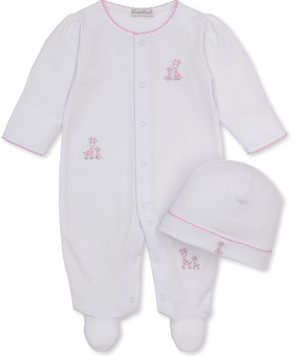 The Kissy Kissy Baby Just Giraffes Footie with Hat Set features a white footed onesie with pink trim and adorable giraffe embroidery, crafted from ultra-soft Pima cotton for delicate skin. This charming set also includes a matching white beanie adorned with a sweet pink giraffe design, creating a delightful giraffe-themed look.