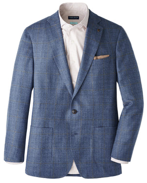 The Delrose Plaid Soft Jacket by Peter Millar features Italian fabric, two buttons, notch lapels, patch pockets, and a beige pocket square over a checkered shirt—a versatile, casually refined wardrobe essential.