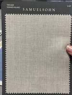 A swatch of light beige textured fabric labeled "Samuelsohn Slim Fit Flat Front Wool Pants," ideal for slim dress pants, is held by a hand on the right edge.