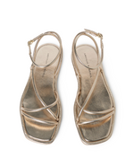 The Loeffler Randall Noor Strappy Ankle Wrap Flat features champagne metallic square toes, thin crisscross straps, and ankle buckles, shown from above.
