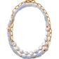 The Porto Covo Necklace by Lizzie Fortunato features a gold-plated brass chain adorned with freshwater pearls, iridescent beads, and light purple rectangular beads.