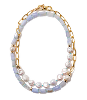 The Porto Covo Necklace by Lizzie Fortunato features a gold-plated brass chain adorned with freshwater pearls, iridescent beads, and light purple rectangular beads.
