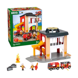 The Brio Central Fire Station playset includes a building, fire engine, firefighter figures, accessories, and comes in branded packaging shown in the background.