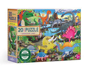 The Eeboo Dinosaur Land 20-Piece Puzzle features colorful illustrations of dinosaurs in a prehistoric landscape on the box and is suitable for ages 3 and up.