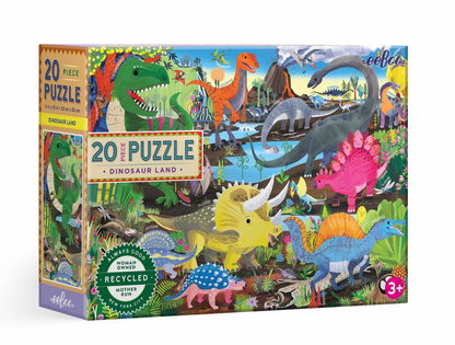 The Eeboo Dinosaur Land 20-Piece Puzzle features colorful illustrations of dinosaurs in a prehistoric landscape on the box and is suitable for ages 3 and up.