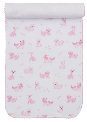 The Kissy Kissy Puppy Paws Printed Burp Cloth is crafted from soft Pima cotton, featuring a pink cartoon puppy and charming puppy paw print pattern, rolled at the top and finished with delicate pink scalloped stitching along the edges.