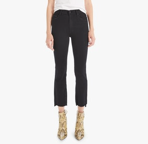 Someone wearing The Insider Crop Step Fray jeans by Mother in classic black, paired with a white top and snakeskin ankle boots, poses against a plain white background.