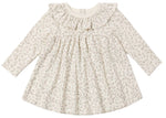The Quincy Mae Baby Girls’ and Girls’ Ruffle Collar Jersey Dress is a long-sleeved, cream-colored dress made from soft brushed jersey. It features a subtle floral print, a charming ruffled collar, and a gathered waist—perfect for everyday wear and shown against a white background.