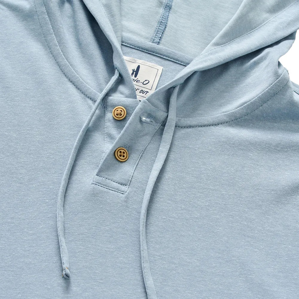 The Jase Hoodie by Johnnie-O features a light blue slub knit fabric, a drawstring hood, two brown buttons on the placket, and a white tag sewn inside the collar. Part of the Hangin’ Out collection, this cotton-blend hoodie combines comfort and style for everyday wear.