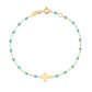 The Gigi Clozeau Classic Cross Charm Bracelet 6.7" showcases a stunning blend of turquoise beads, an 18 carat gold chain, elegant resin pearls, and a central cross charm.