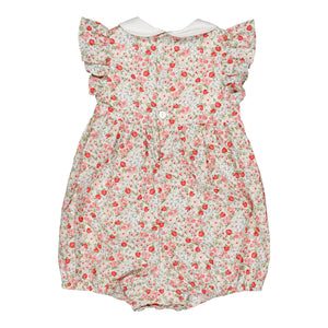 The Kidiwi Baby Girls' Julyne Smocked Girl Romper features short ruffled sleeves, a Peter Pan collar, back button closure, and a cream base with small red and pink floral patterns.