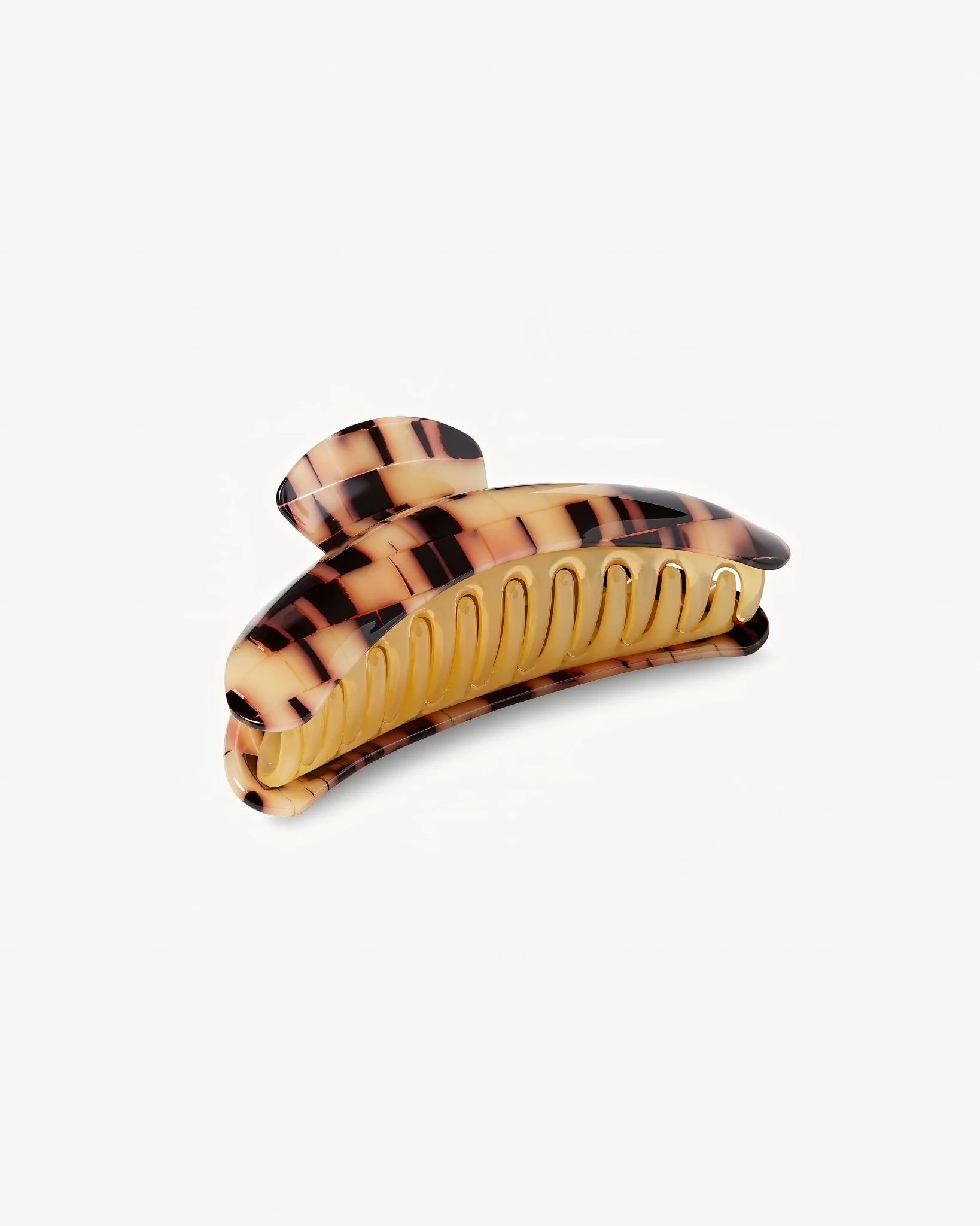 The Jumbo Heirloom Claw by Machete is a large claw clip made from luxurious Italian acetate in a tortoiseshell pattern, designed with curved edges and interlocking teeth to securely hold thick hair. It is displayed against a plain white background.