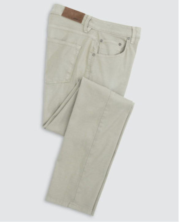 The Johnnie-O Atlas 5-Pocket Pant in light beige stretch twill is garment-dyed, lightweight, and perfect for warm weather. Neatly folded to display back pockets and a brown leather waistband patch.