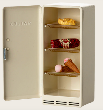 An off-white Maileg Fridge, Mouse with its door open, displaying a cookie, a roll of salami, and an ice cream cone on the shelves—perfect dollhouse accessories to inspire imaginative storytelling play.