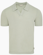 The Onia Boucle Knit Johnny Polo features a light green, short-sleeve design with an open V-neck and relaxed silhouette, displayed against a plain white background.