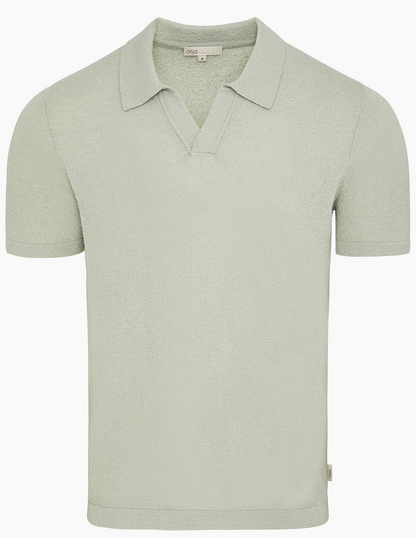 The Onia Boucle Knit Johnny Polo features a light green, short-sleeve design with an open V-neck and relaxed silhouette, displayed against a plain white background.