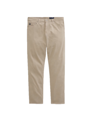 Showcased on a white background, the Tellis Sueded Sateen Jeans by AG Jeans are a pair of beige men’s pants crafted from stretch sateen fabric, featuring a modern slim jean silhouette with front and back pockets, belt loops, and a button closure.