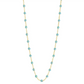 The Gigi Clozeau Classic Gigi Necklace 16.5" by Gigi Clozeau showcases an 18 carat yellow gold chain decorated with vibrant turquoise beads, creating a captivating piece of jewelry.