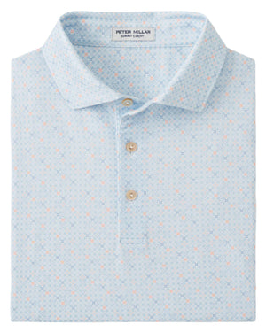 The Peter Millar Castellina Performance Jersey Polo features a light blue geometric pattern, three beige buttons, and four-way stretch fabric for comfort and ease of movement.