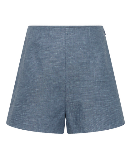 Front view of POSSE's Thea Short in blue chambray linen, showing its subtle textured pattern, flat waistband, and adjustable tabs for a custom fit.