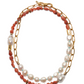 The Porto Covo Necklace by Lizzie Fortunato is a gold-plated chain link necklace with alternating segments of red beads and freshwater pearls, finished with a toggle clasp.