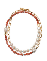 The Porto Covo Necklace by Lizzie Fortunato is a gold-plated chain link necklace with alternating segments of red beads and freshwater pearls, finished with a toggle clasp.