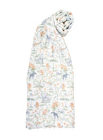 A rolled-up Timo & Violet Shawl Blanket made from white organic cotton, featuring a pastel animal and nature print with elephants, giraffes, and trees.