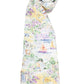 The Timo & Violet Shawl Blanket features a colorful, coastal print with houses, flowers, sailboats, and umbrellas on a white background.