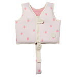 The Sunnylife Kids' Swim Vest in light pink features small strawberry prints, a front zipper, velcro strap, and an anti-rise safety strap that fastens between the legs for a secure fit. It is designed with a neoprene comfort guard to keep your child comfortable while swimming.