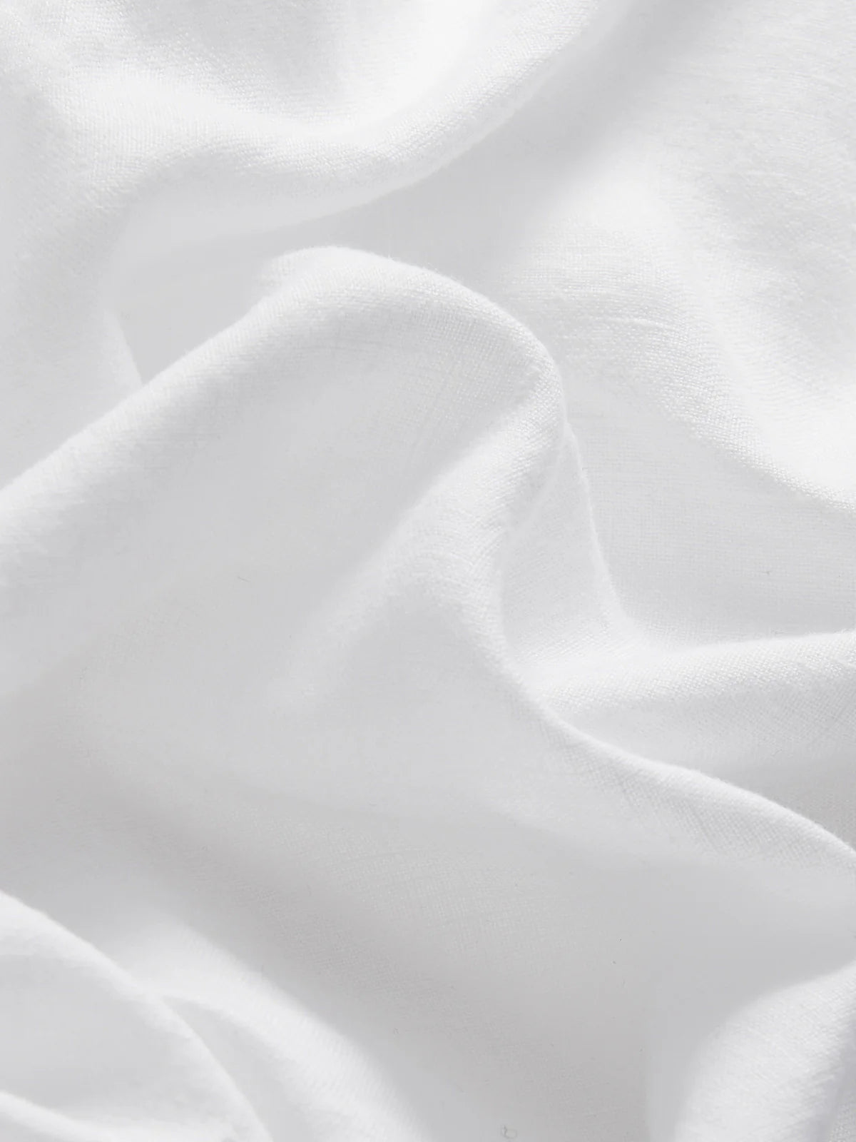 Close-up of white fabric with soft folds and creases, ideal for the Love Brand Boys' Joulter Linen Short.