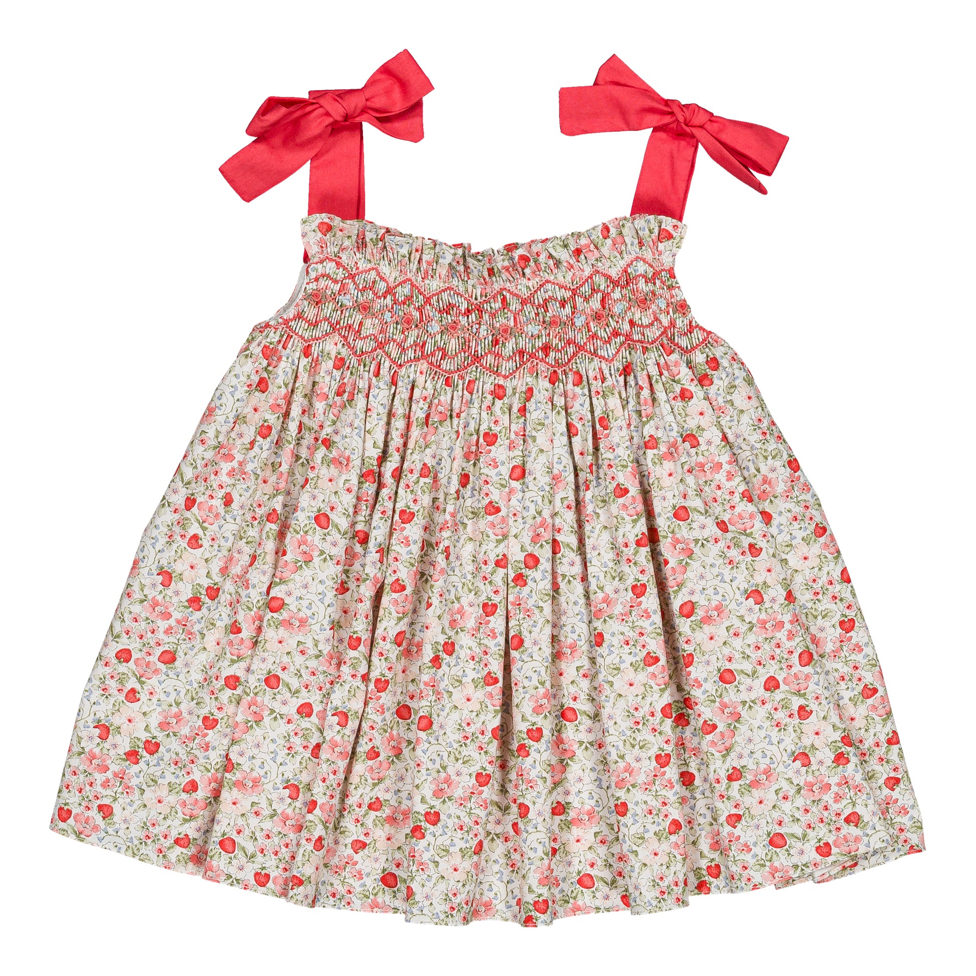 The Kidiwi Baby Girls' and Girls' Sariette Smocked Blouse features a smocked bodice, cherry red print shoulder bows, and red and pink floral patterns on white 100% cotton.