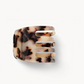 The Machete Mini Claw, a bio-acetate hair clip with a tortoiseshell pattern and four wide prongs, is displayed on a plain white background—ideal for securing different hair types.