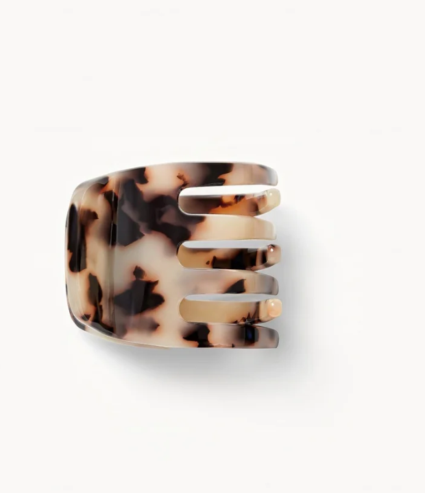 The Machete Mini Claw, a bio-acetate hair clip with a tortoiseshell pattern and four wide prongs, is displayed on a plain white background—ideal for securing different hair types.