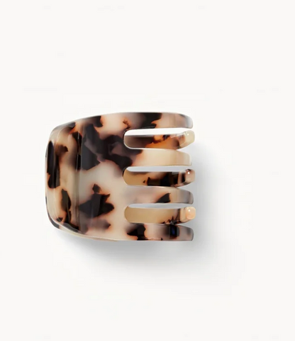 The Machete Mini Claw, a bio-acetate hair clip with a tortoiseshell pattern and four wide prongs, is displayed on a plain white background—ideal for securing different hair types.