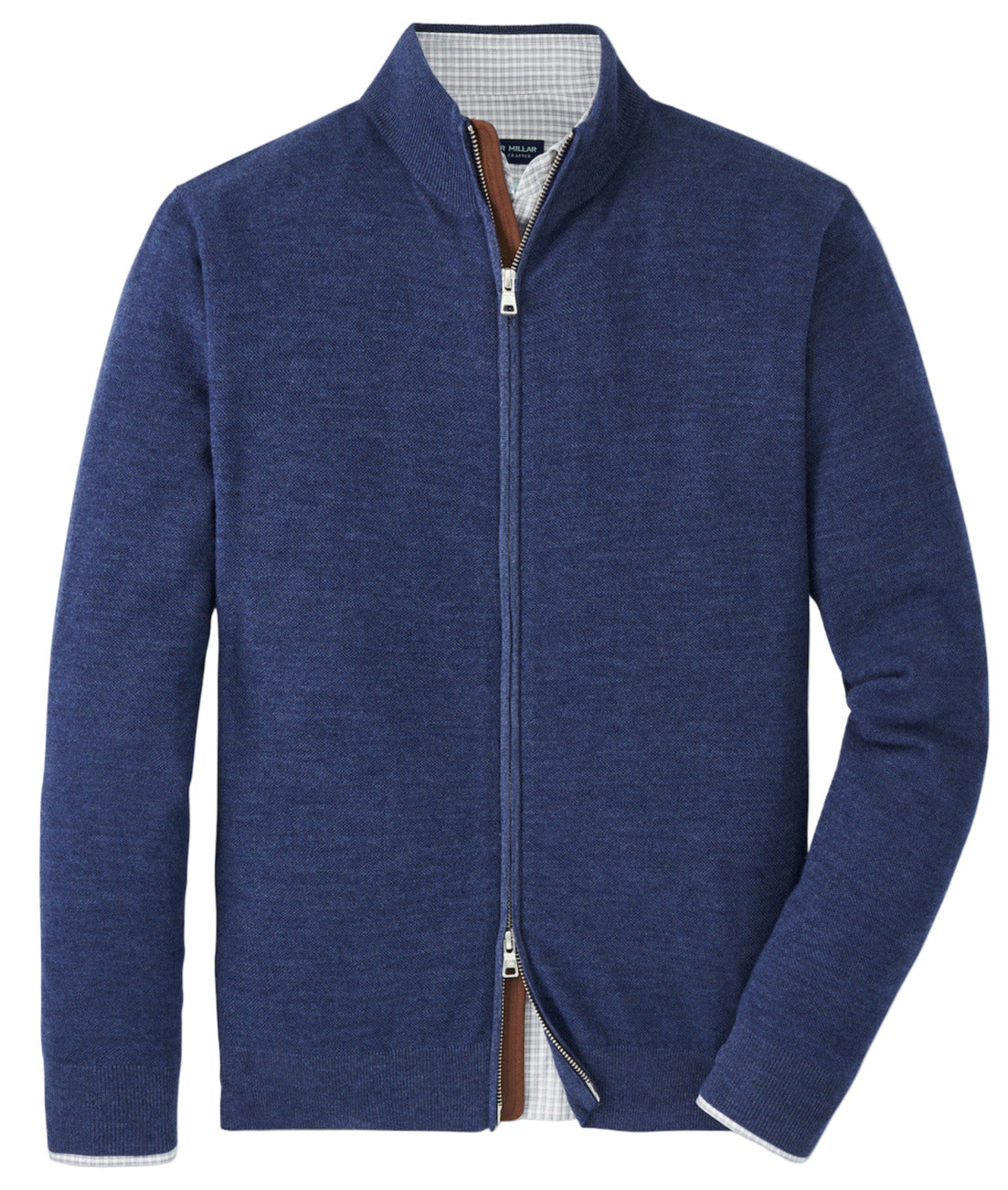 The Peter Millar Excursionist Flex Full-Zip Sweater in blue Merino wool, featuring a high collar, is shown flat on a white background with part of a checked shirt visible underneath.