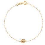 The Gigi Clozeau Madone Charm Bracelet 6.7" by Gigi Clozeau is crafted from 18 carat gold, featuring elegant resin pearls and a central oval medallion.