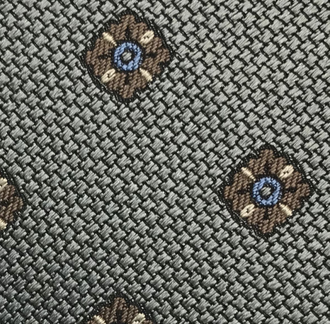 Close-up of the Large Diamond Pattern Tie by Robert Jensen, showcasing a woven gray fabric with evenly spaced brown and blue diamond shapes—perfect for adding personal style to your handcrafted necktie.
