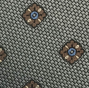 Close-up of the Large Diamond Pattern Tie by Robert Jensen, showcasing a woven gray fabric with evenly spaced brown and blue diamond shapes—perfect for adding personal style to your handcrafted necktie.