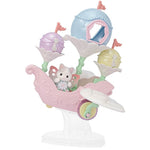 The Calico Critters Floral Fantasy Skyship features Latte Cat Baby dressed in a delicate fairy costume with butterfly wings, seated in a pastel pink and white carnival ride shaped like a carriage with three flower-shaped seats and pastel flags, all displayed on a clear stand.