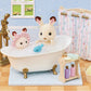 Two Calico Critters enjoy a bubble-filled Bath & Shower Set with a blue toy fish, surrounded by bath time accessories and an antique-style bath fitting in a charming dollhouse bathroom.