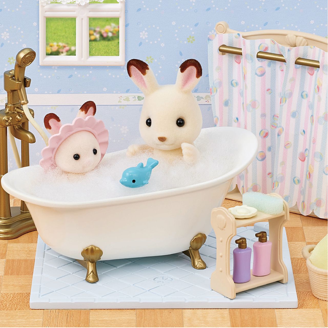 Two Calico Critters enjoy a bubble-filled Bath & Shower Set with a blue toy fish, surrounded by bath time accessories and an antique-style bath fitting in a charming dollhouse bathroom.