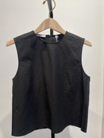 The Linen Crew Neck Shell Tank by vince is a sleeveless black top crafted from a lightweight, breathable linen blend, shown on a wooden hanger against a plain white background.
