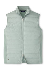 The Peter Millar Winsome Hybrid Vest is a light green, channel-insulated sleeveless vest with a two-way zip front and stand-up collar, shown laid flat on a white background.