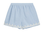 Girls’ Vally Shorts by Louise Misha in light blue Oxford cotton, featuring an elasticized waist and delicate white floral embroidery along the hem, displayed flat on a white background.