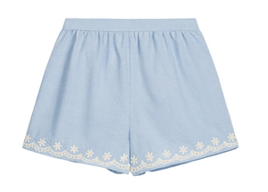 Girls’ Vally Shorts by Louise Misha in light blue Oxford cotton, featuring an elasticized waist and delicate white floral embroidery along the hem, displayed flat on a white background.
