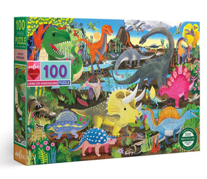 The eeboo Land of Dinosaurs 100 Piece Puzzle by Eeboo is a vibrant jigsaw puzzle showcasing a diverse collection of dinosaurs set in an eye-catching prehistoric landscape, ideal for those passionate about paleontology.