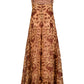 The Day Rhythms Ankle Dress by Johanna Ortiz is a sleeveless brown midi with thin straps, an A-line silhouette, and detailed gold floral embroidery.