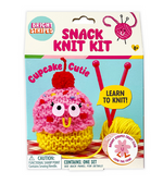 The Bright Stripes Snack Knit Kit - Cupcake Cutie package displays a finished pink and yellow cupcake plush, two red knitting needles, and a ball of yellow yarn. Ideal for beginner knitters, this crafty set features the phrases “Cupcake Cutie” and “Learn to Knit!” on the packaging.
