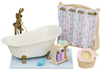 The Calico Critters Bath & Shower Set features an antique-style bath fitting, charming clawfoot tub, shower curtain, shelf with bottles, blue toy whale, laundry basket, and sponge on a tiled mat—an adorable collection of bath time accessories to enhance your dollhouse furniture set.