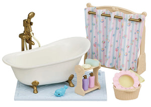 The Calico Critters Bath & Shower Set features an antique-style bath fitting, charming clawfoot tub, shower curtain, shelf with bottles, blue toy whale, laundry basket, and sponge on a tiled mat—an adorable collection of bath time accessories to enhance your dollhouse furniture set.